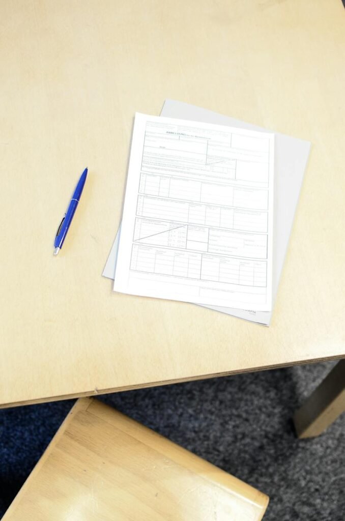 Registration form with pen on table in workspace